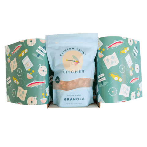 Three packages of Rainbow Trout Kitchen granola with gift wrapping paper